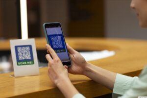 A person at a cashless store using her phone to make a QR code payment