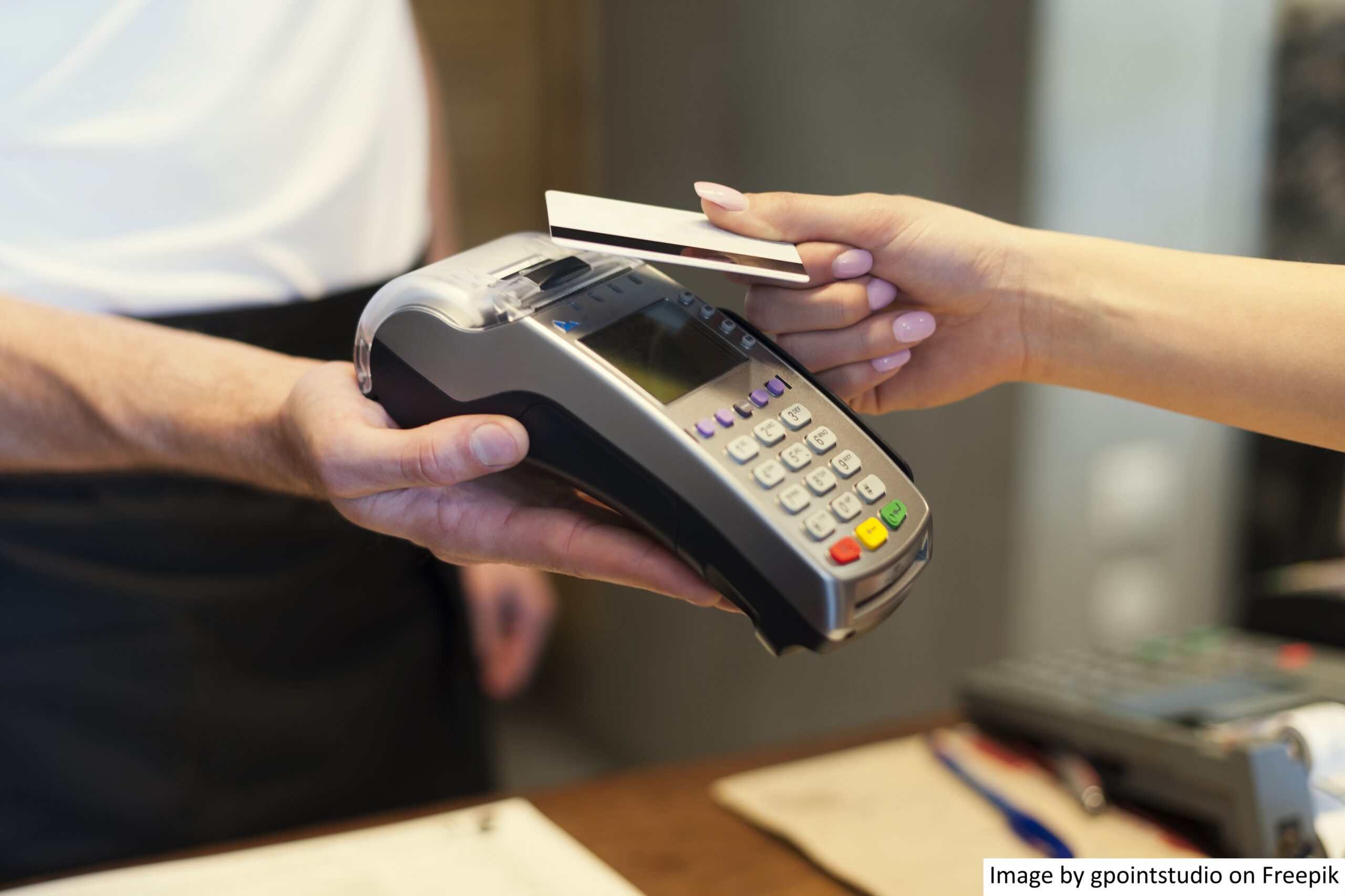 A person completing a transaction using a retail payment solution in a Southeast Asian shop. 